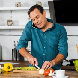 man chopping vegetables in a kitchen